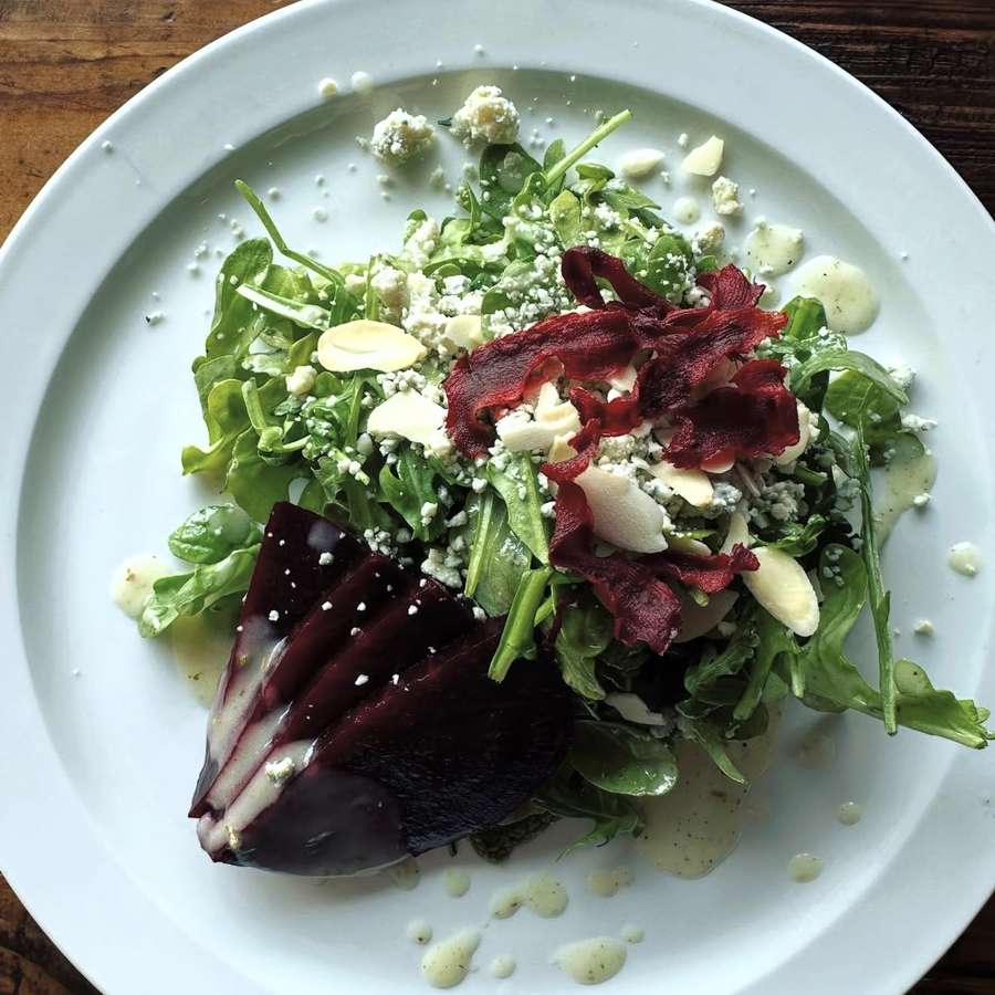 Beet salad with arugula, blue cheese, almonds and beet chips