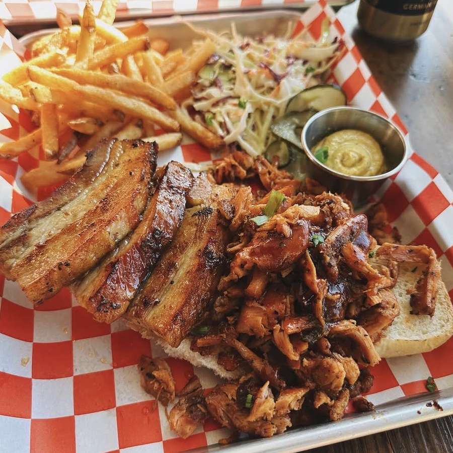 Smoked pork belly and pulled chicken tray with fries and slaw