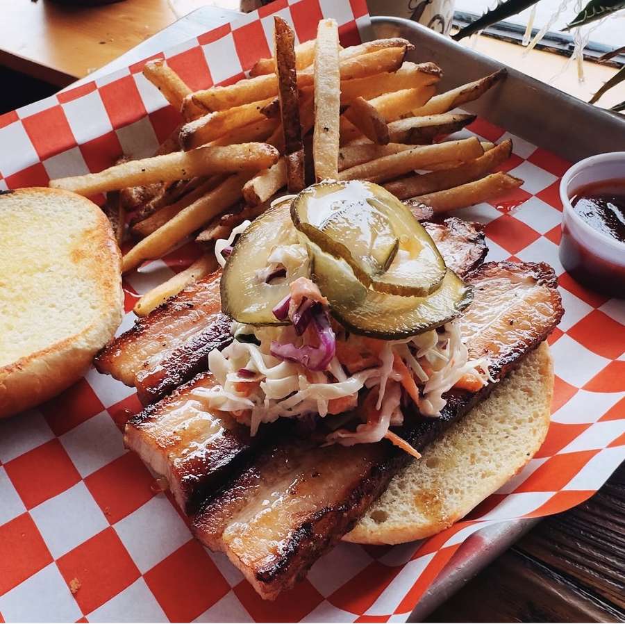Smoked pork belly sandwich with coleslaw and pickles