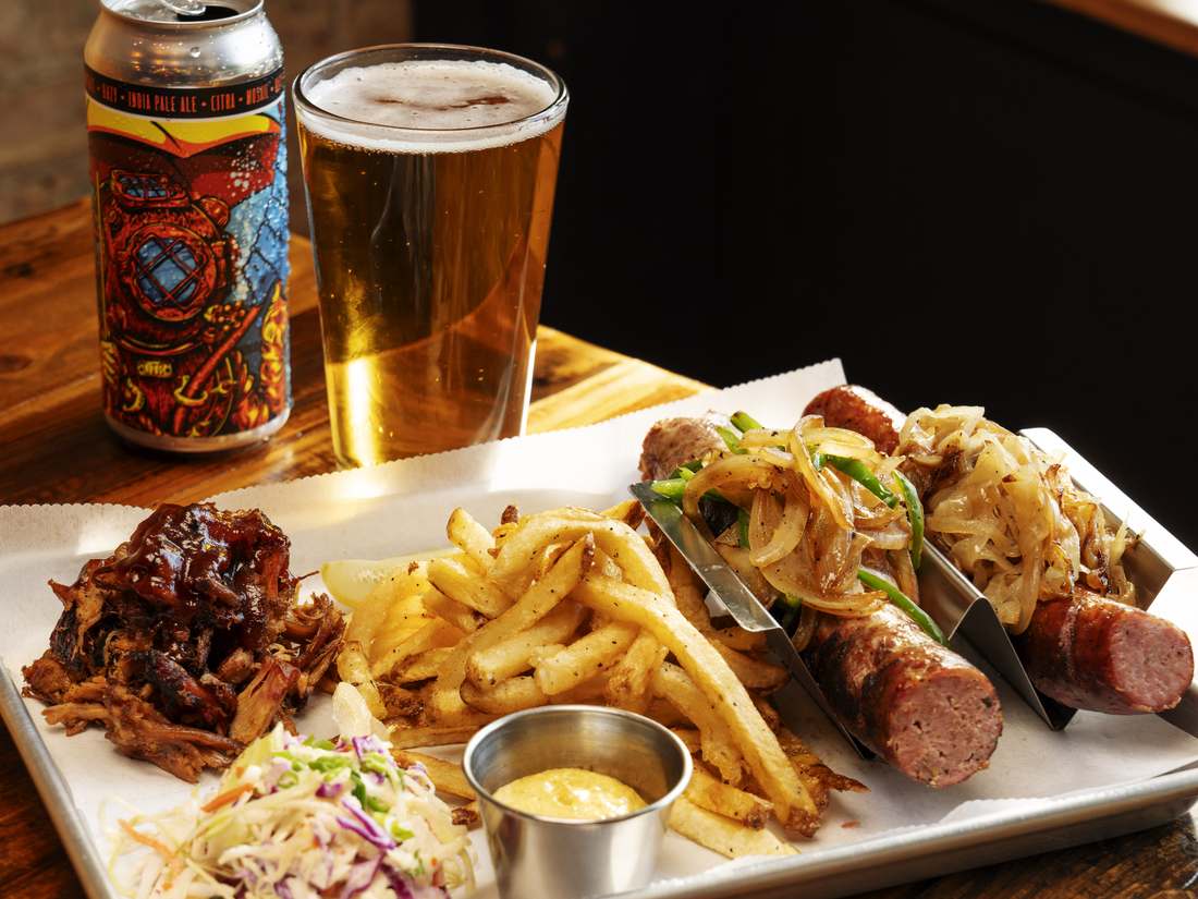 Smoked platter with sausages, pulled pork, coleslaw and fries at Wurst Behavior