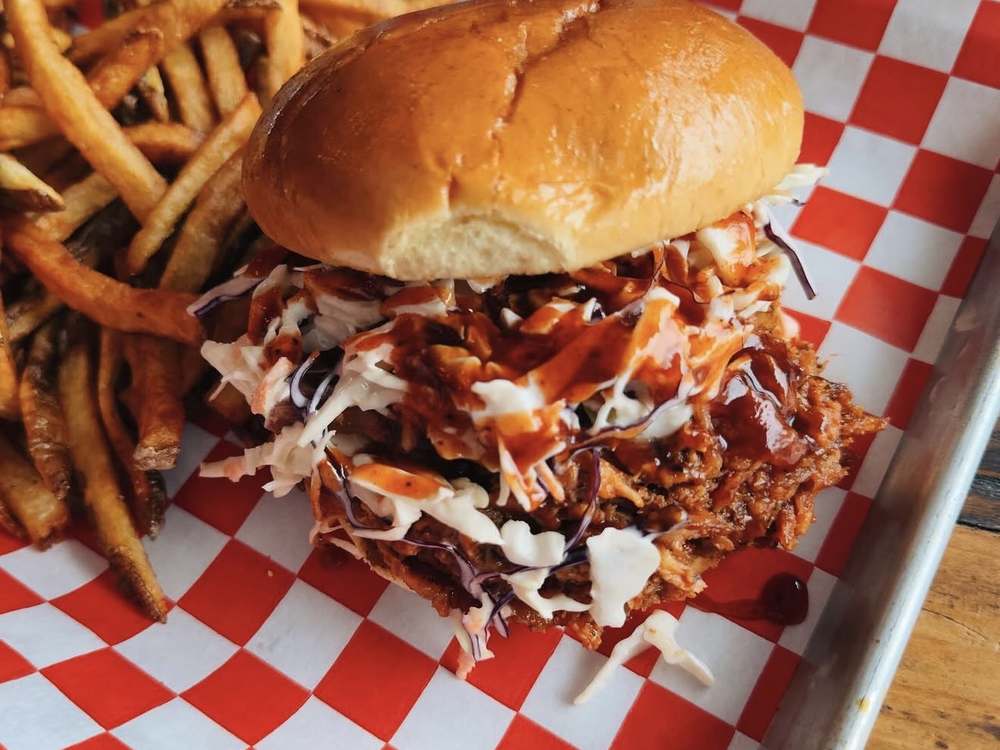 14 hour pecan smoked pulled pork sandwich with coleslaw and house BBQ at Wurst Behavior